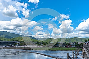 Togetsu-kyo bridge over katsuragawa river with colourful forest mountain background in Arashiyama district.