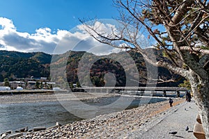 Togetsu-kyo bridge over katsuragawa river with colourful forest mountain background in Arashiyama district.