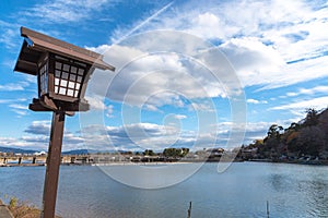 Togetsu-kyo bridge over katsuragawa river with colourful forest mountain background in Arashiyama district.