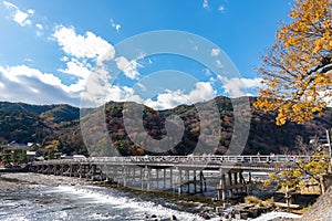 Togetsu-kyo bridge over katsuragawa river with colourful forest mountain background in Arashiyama district.