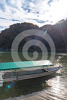 Togetsu-kyo bridge over katsuragawa river with colourful forest mountain background in Arashiyama district.