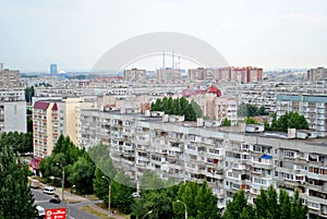 Panorama of residential areas of the summer city in the early morning from the height of the 16th floor of a residential building.