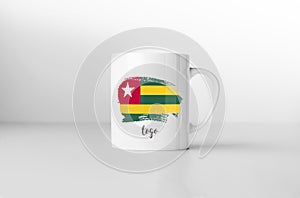 Togo flag on white coffee mug.