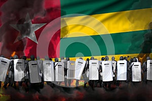 Togo protest fighting concept, police special forces in heavy smoke and fire protecting order against disorder - military 3D