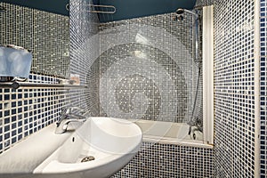 Toilet with bathtub and white porcelain sink, square wall mirror