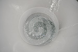 Toilet bowl flush. Water splash. Water flushes down toilet bowl. Water close-up. Toilet. Toilet in bathroom.