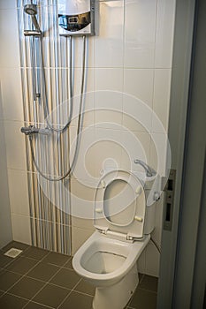 White toilet bowl and shower set in HDB BTO apartment.