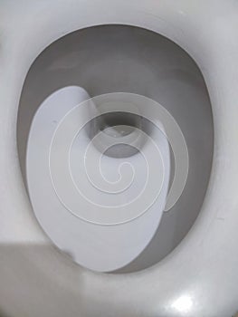 Toilet, Flushing Water, close up illuminated by artificial light