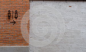 Toilet icon on brick wall