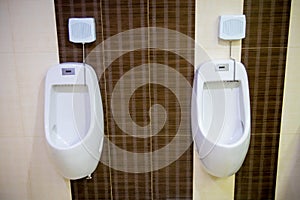 toilet men`s room.Close up row of outdoor urinals men public toilet,Closeup white urinals in men`s bathroom