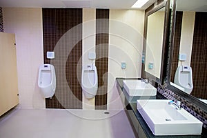 Toilet men`s room.Close up row of outdoor urinals men public toilet,Closeup white urinals in men`s bathroom