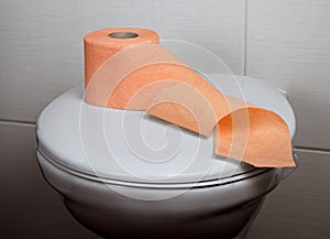 Toilet with orange toilet paper