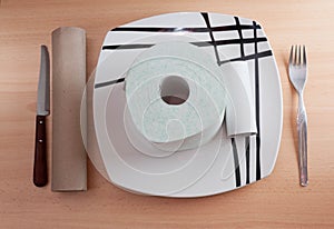 Toilet paper and cardboard food on oak table