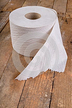 Toilet paper on an old wooden table. Hygienic items in the workshop