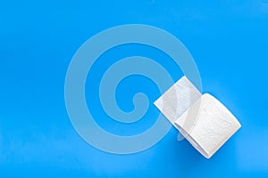 Toilet paper for proctology diseases concept on blue background top view mockup