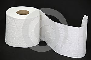 Toilet paper roll on black background