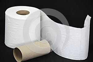 Toilet paper roll on black background photo