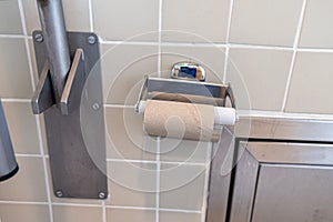 Toilet paper roll finished in a public toilet. Frustration concept.
