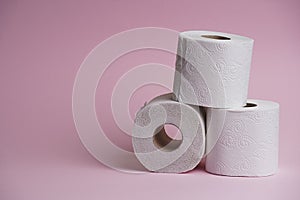 Toilet paper roll on pink background. Hygienic soft paper