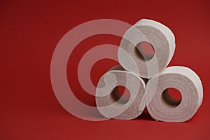 Toilet paper roll on red background. Soft hygienic paper