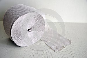 Toilet paper roll on a white surface. Excellent adhesion and strength photo