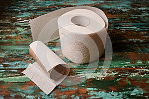 Toilet paper roll on the wooden table.