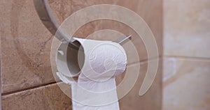 Toilet paper roller spins, napkin paper ends up unwinding. Trouble in restroom