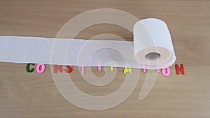 toilet paper rolling constipation symbol with alphabet letters