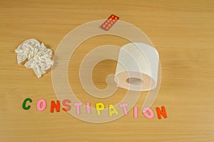 Toilet paper rolling constipation symbol with alphabet letters moving with a pillbox