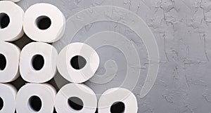 Toilet paper rolls on gray background