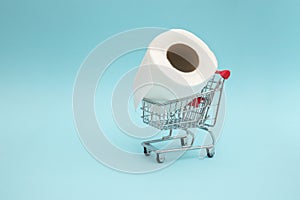 Toilet paper in the shopping trolley. Concept of high demand and shortage of toilet paper in the market