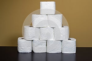 Toilet paper shortage concept with stacked rolls.