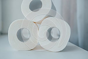 Toilet paper shortage concept with stacked rolls.