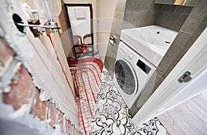 Toilet room with heated floor before and after renovation.