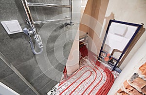 Toilet room with heated floor before and after renovation.