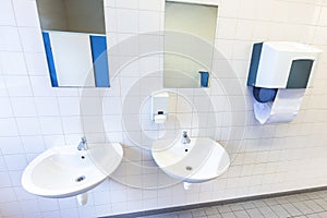 Toilet room for men with sinks and mirrors