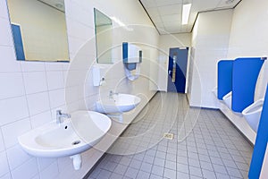 Toilet room for men with urinals sinks and mirrors