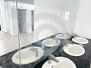 Toilet room for men with urinals sinks and mirrors