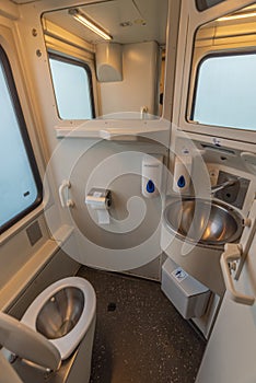 Toilet room with wash basin and mirror in expres train in cold winter day