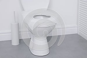 Toilet seat with paper tissues in bathroom