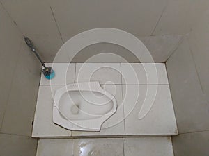 A Toilet Sets in Indonesia consisted of Squat Toilet and Brush