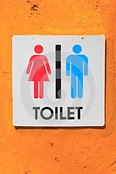 Toilet sign on orange background