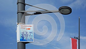 toilet sign on a street light, Bremerhaven, Germany