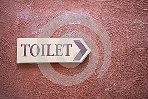 Toilet sign on vintage wall