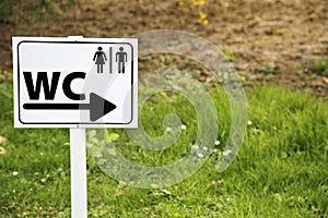 Toilet sing for man and female on white table in nature