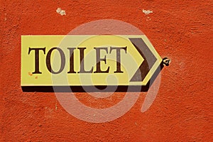 Toilet vintage label on a brown background.