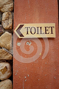 Toilet vintage label on a brown background.