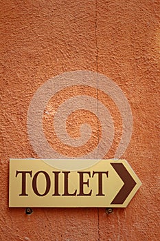 Toilet vintage label on a brown background.