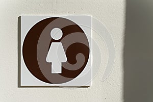 Toilet for women with the symbol of a woman on the door