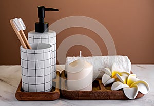 Toiletries composition on  marble table against  brown wall. Spa concept